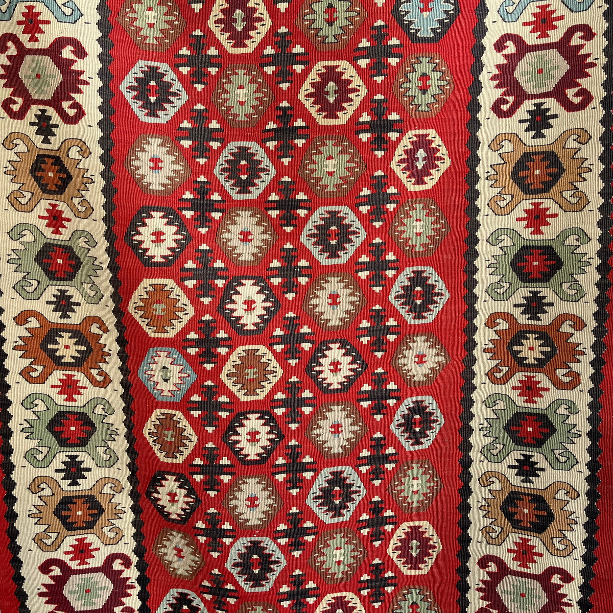 1970s red vintage Turkish persian runner rug with traditional design, flatweave construction and low pile.