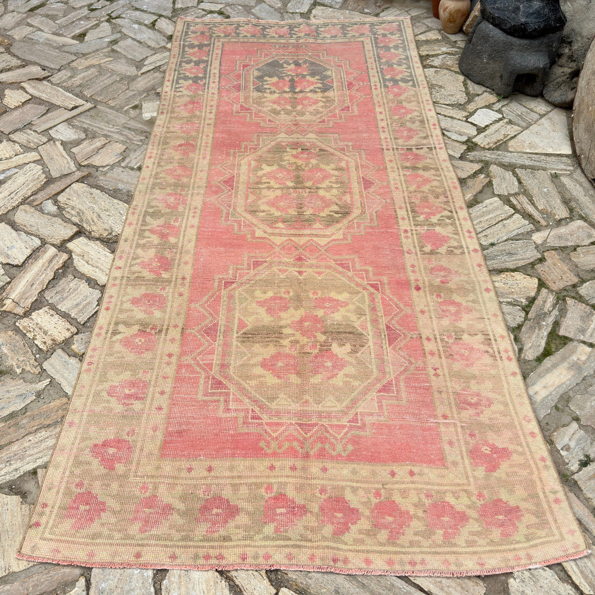 Pink 4' x 10' vintage Turkish persian runner rug in wool and cotton, shown on the floor.