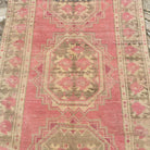 1970s pink vintage Turkish persian runner rug with traditional design, hand-knotted weave and low pile.