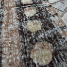 Close-up of the brown vintage Turkish persian style rug showing geometric details, hand-knotted weave, wool and cotton and low pile.