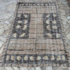 Brown 5' x 8' vintage Turkish persian style rug in wool and cotton, shown on the floor.