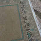 Close-up of the beige vintage Turkish prayer rug showing traditional details, hand-knotted weave, wool and cotton and low pile.