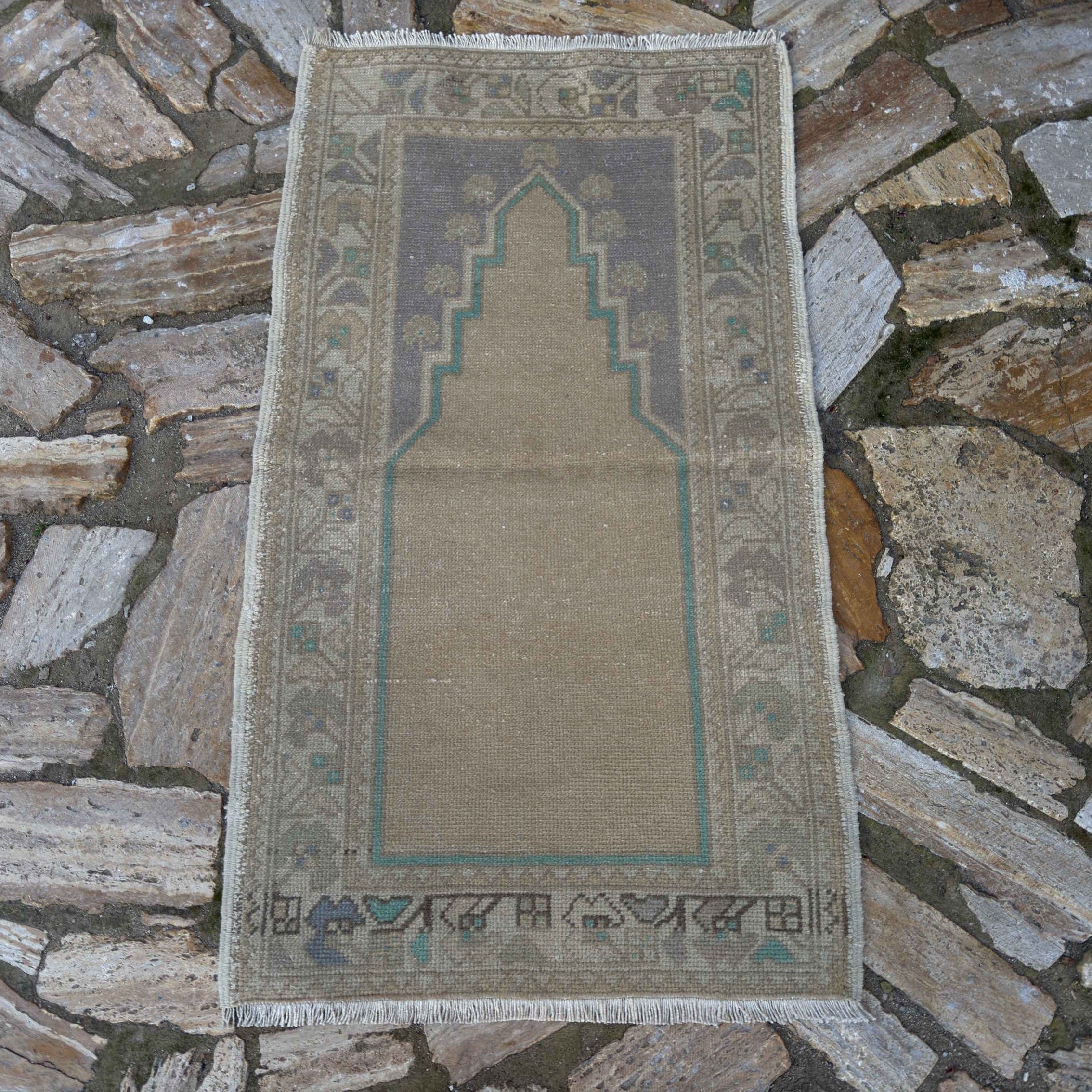 Beige 2' x 4' vintage Turkish prayer rug in wool and cotton, shown on the floor.