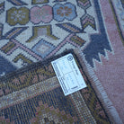 Pink 2' x 4' vintage Turkish rug from the 1970s with traditional design.