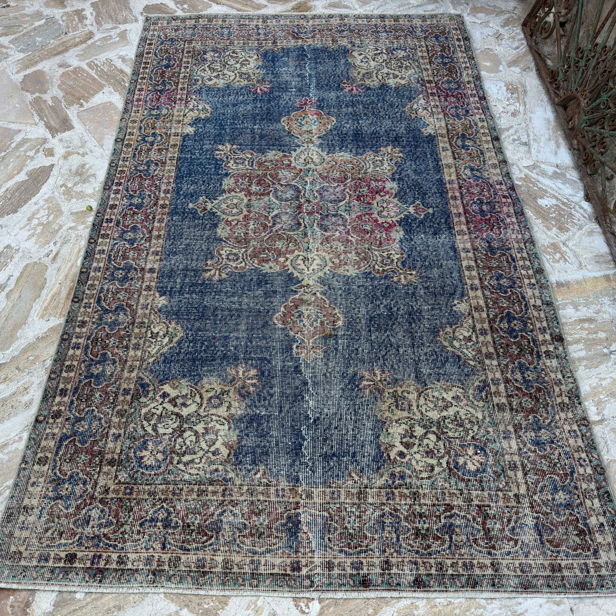 Blue 5' x 8' vintage Turkish rug in wool and cotton, shown on the floor.