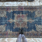 1970s blue vintage Turkish rug with medallion design, hand-knotted weave and low pile.