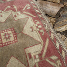 Close-up of the pale red vintage Turkish runner carpet showing traditional details, hand-knotted weave, wool and cotton and low pile.