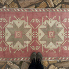 1970s pale red vintage Turkish runner carpet with traditional design, hand-knotted weave and low pile.