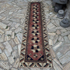Pale Red 2' x 10' vintage Turkish runner rug in wool and cotton, shown on the floor.