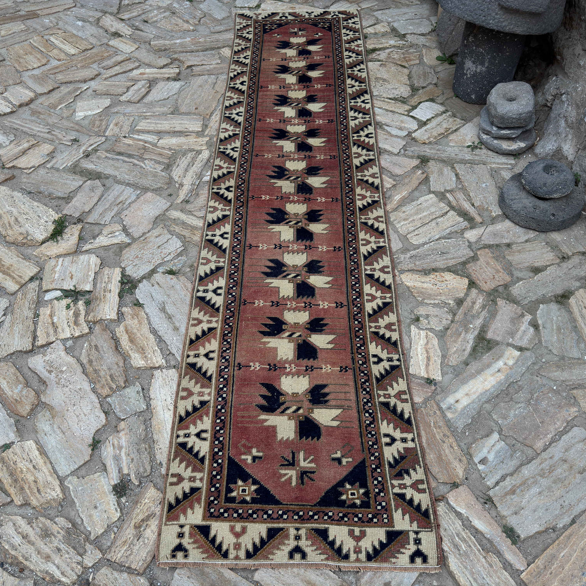 Pale Red 2' x 10' vintage Turkish runner rug in wool and cotton, shown on the floor.