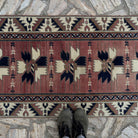 1970s pale red vintage Turkish runner rug with traditional design, hand-knotted weave and low pile.