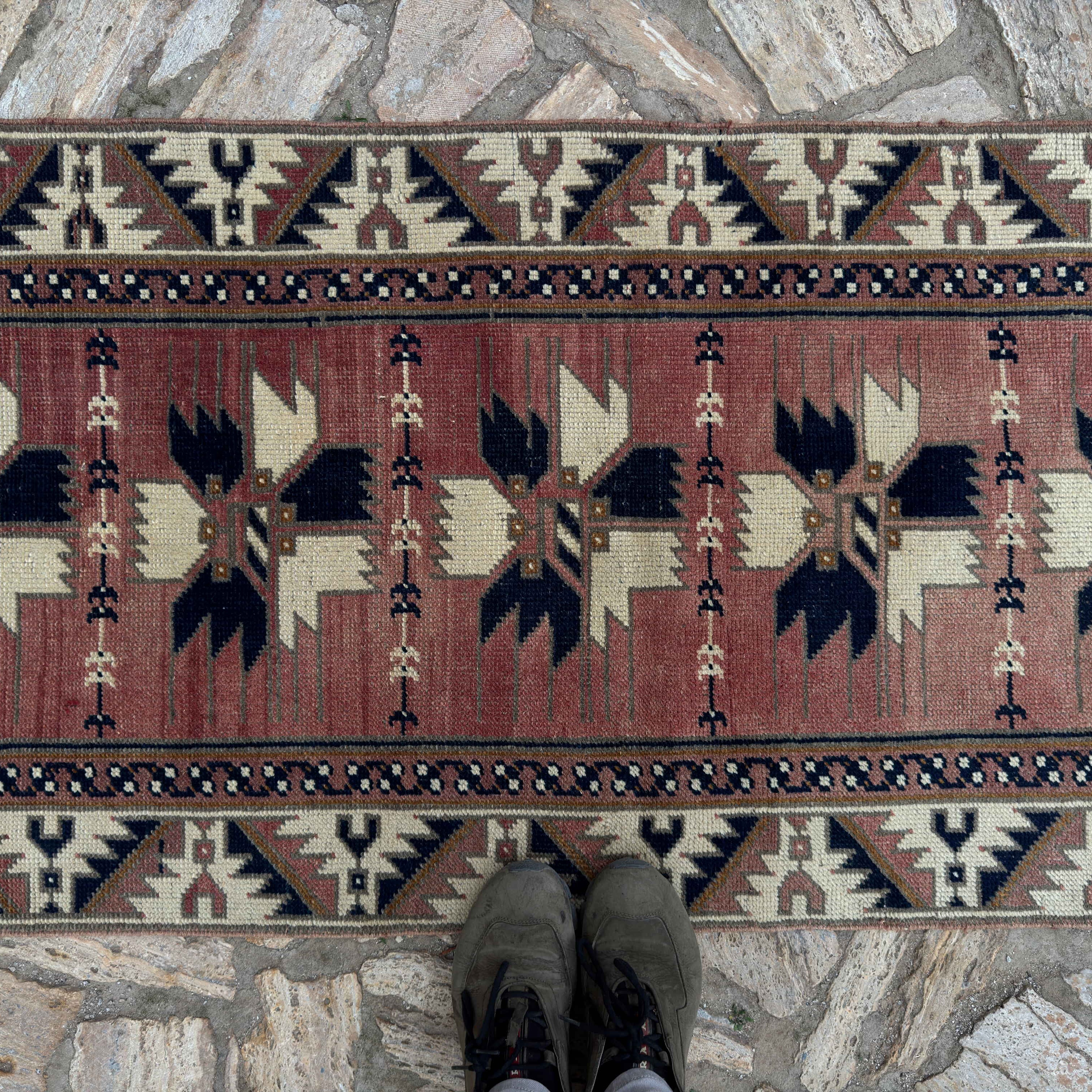 1970s pale red vintage Turkish runner rug with traditional design, hand-knotted weave and low pile.