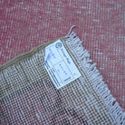 Pink 2' x 8' vintage Turkish runner rug from the 1970s with traditional design.