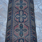 Close-up of the red vintage Turkish runner rug showing traditional details, hand-knotted weave, wool and low pile.