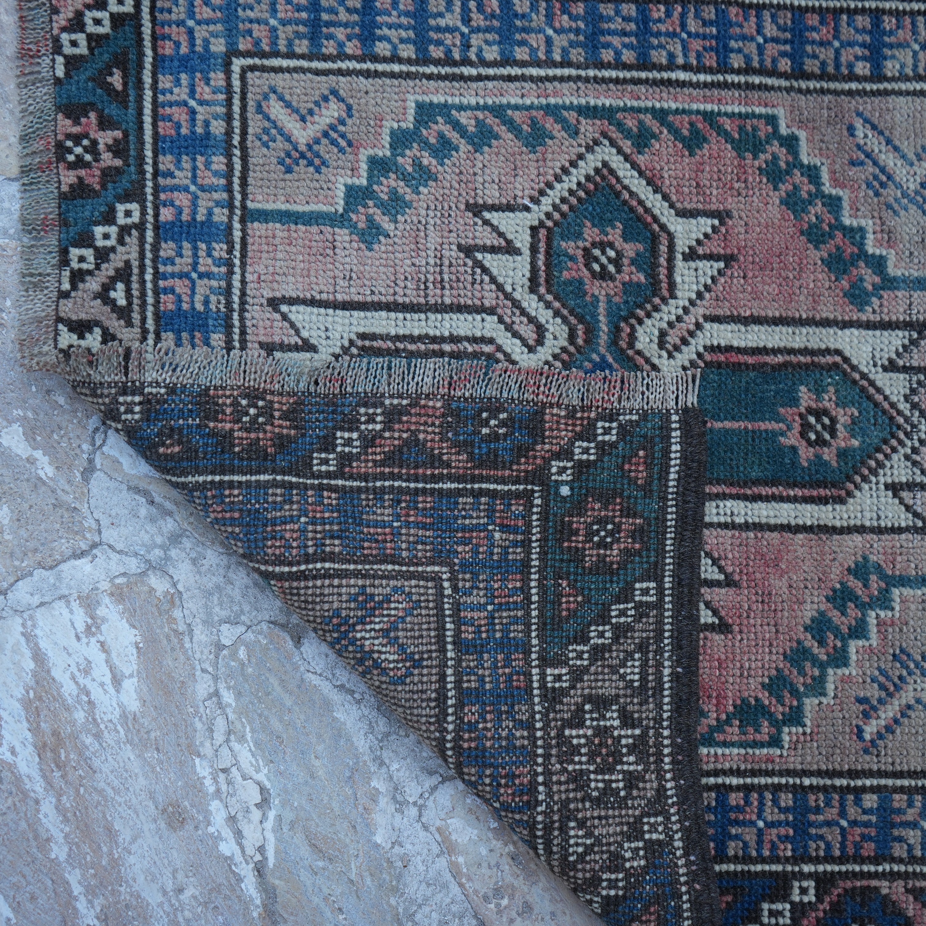 1970s red vintage Turkish runner rug with traditional design, hand-knotted weave and low pile.