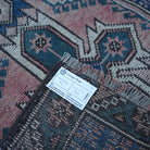 Red 2' x 9' vintage Turkish runner rug from the 1970s with traditional design.