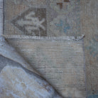 1970s beige vintage Turkish runner rug with floral design, hand-knotted weave and low pile.