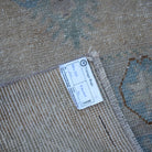 Beige 3' x 11' vintage Turkish runner rug from the 1970s with floral design.