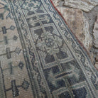 Close-up of the beige vintage Turkish runner rug showing traditional details, hand-knotted weave, wool and cotton and low pile.