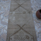 Close-up of the beige vintage Turkish runner rug showing neutral details, hand-knotted weave, wool and cotton and low pile.