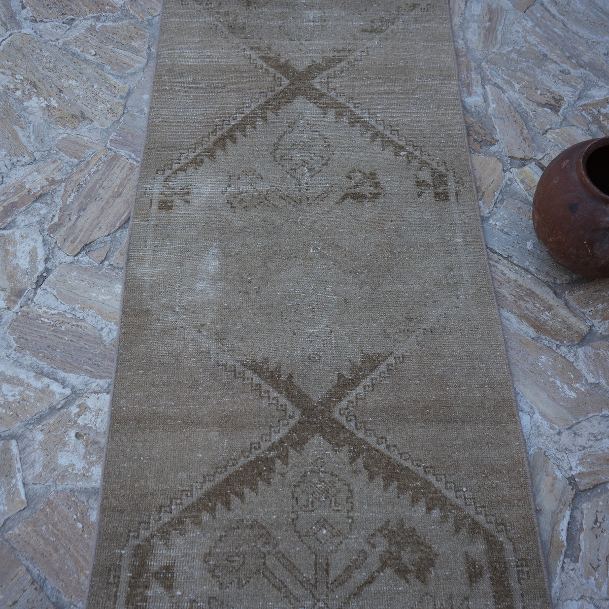Close-up of the beige vintage Turkish runner rug showing neutral details, hand-knotted weave, wool and cotton and low pile.