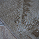 Beige 3' x 11' vintage Turkish runner rug in wool and cotton, shown on the floor.