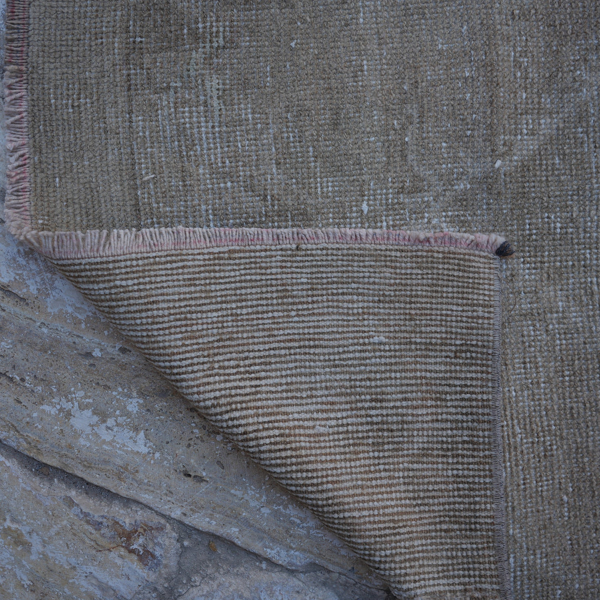 1970s beige vintage Turkish runner rug with neutral design, hand-knotted weave and low pile.