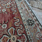 Close-up of the red vintage Turkish runner rug showing traditional details, hand-knotted weave, wool and cotton and low pile.