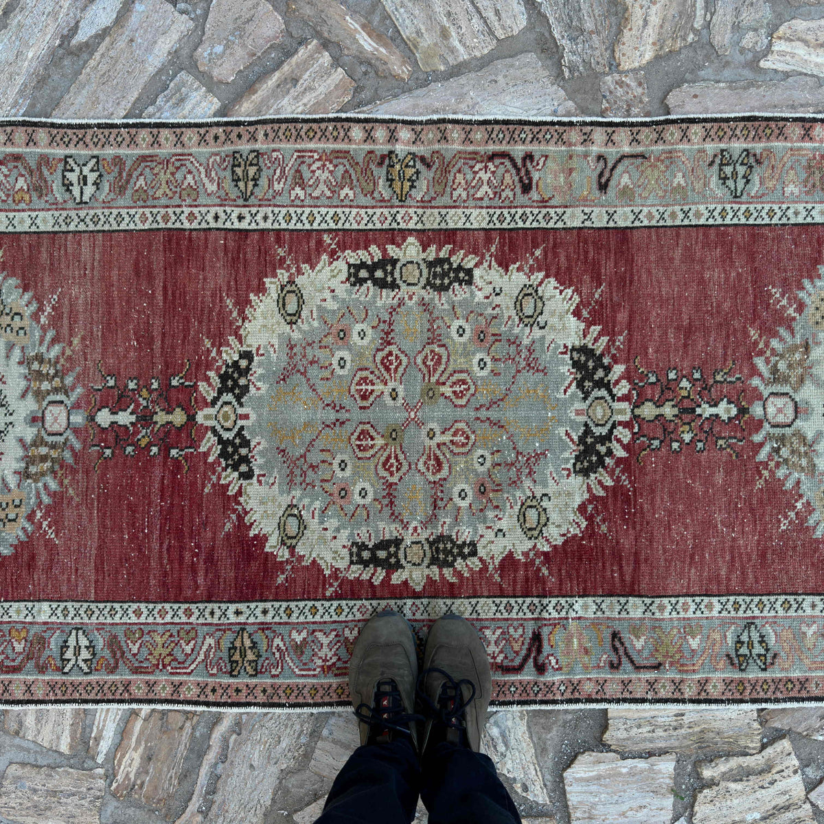 1970s red vintage Turkish runner rug with traditional design, hand-knotted weave and low pile.