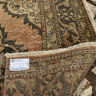 Close-up of the orange vintage Turkish runner rug showing geometric details, hand-knotted weave, wool and cotton and low pile.