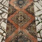 1970s orange vintage Turkish runner rug with geometric design, hand-knotted weave and low pile.