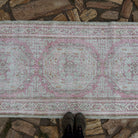 1970s pale pink vintage Turkish runner rug with neutral design, hand-knotted weave and low pile.