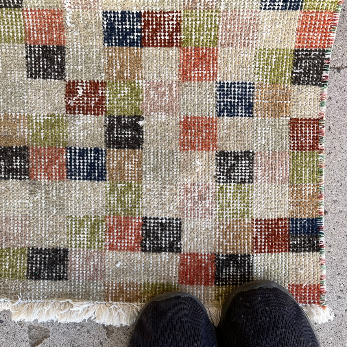 Close-up of the beige vintage Turkish runner rug showing traditional details, hand-knotted weave, wool and cotton and low pile.