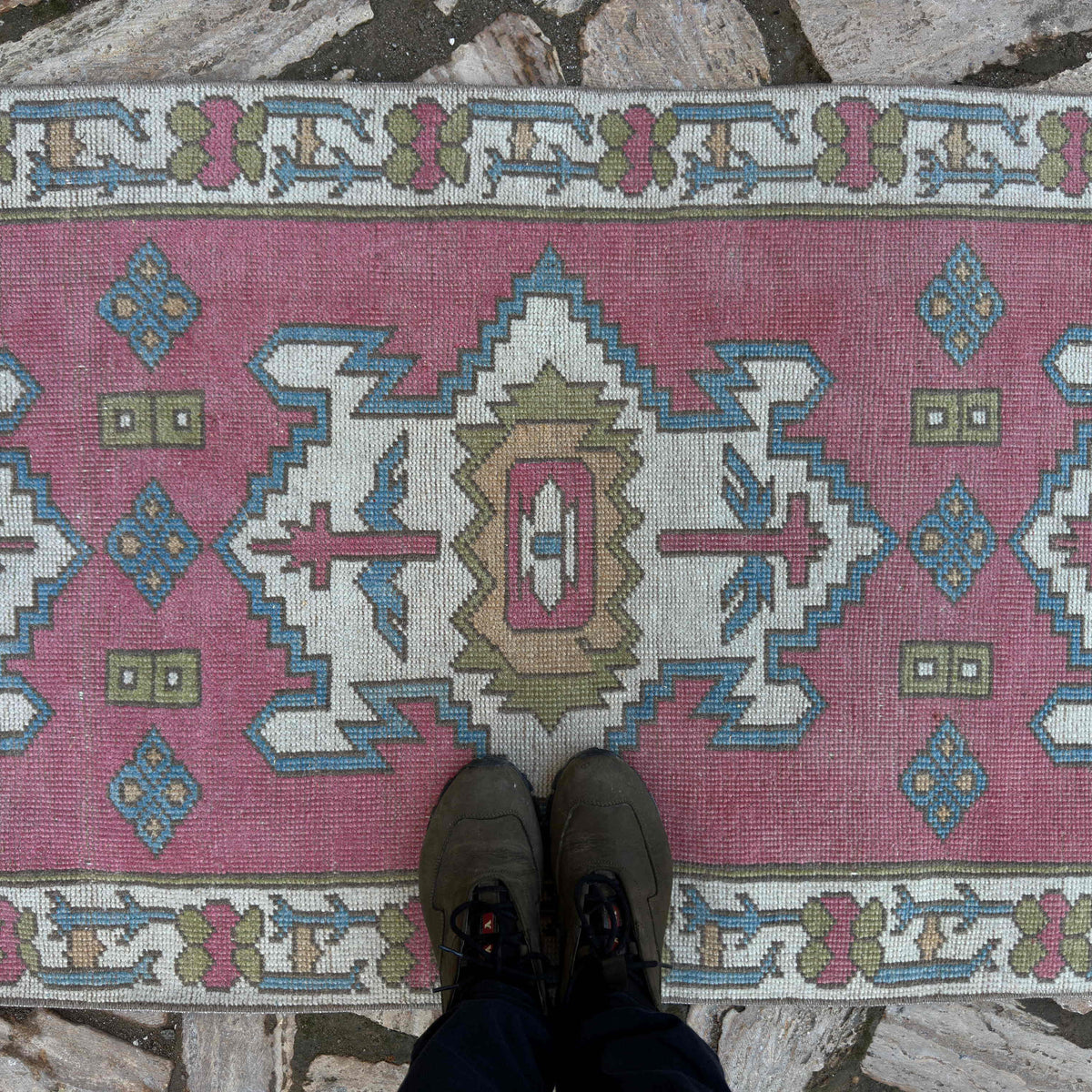 Pink 3' x 8' vintage Turkish runner rug in wool and cotton, shown on the floor.
