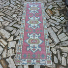 1970s pink vintage Turkish runner rug with traditional design, hand-knotted weave and low pile.