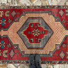 1970s red vintage Turkish runner rug with traditional design, hand-knotted weave and low pile.