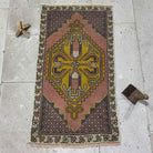 Pink 2' x 3' vintage Turkish small carpet in wool and cotton, shown on the floor.