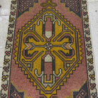1970s pink vintage Turkish small carpet with traditional design, hand-knotted weave and low pile.