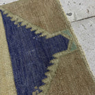 Close-up of the blue vintage Turkish small rug showing neutral details, hand-knotted weave, wool and cotton and low pile.