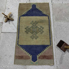Blue 1' x 2' vintage Turkish small rug in wool and cotton, shown on the floor.