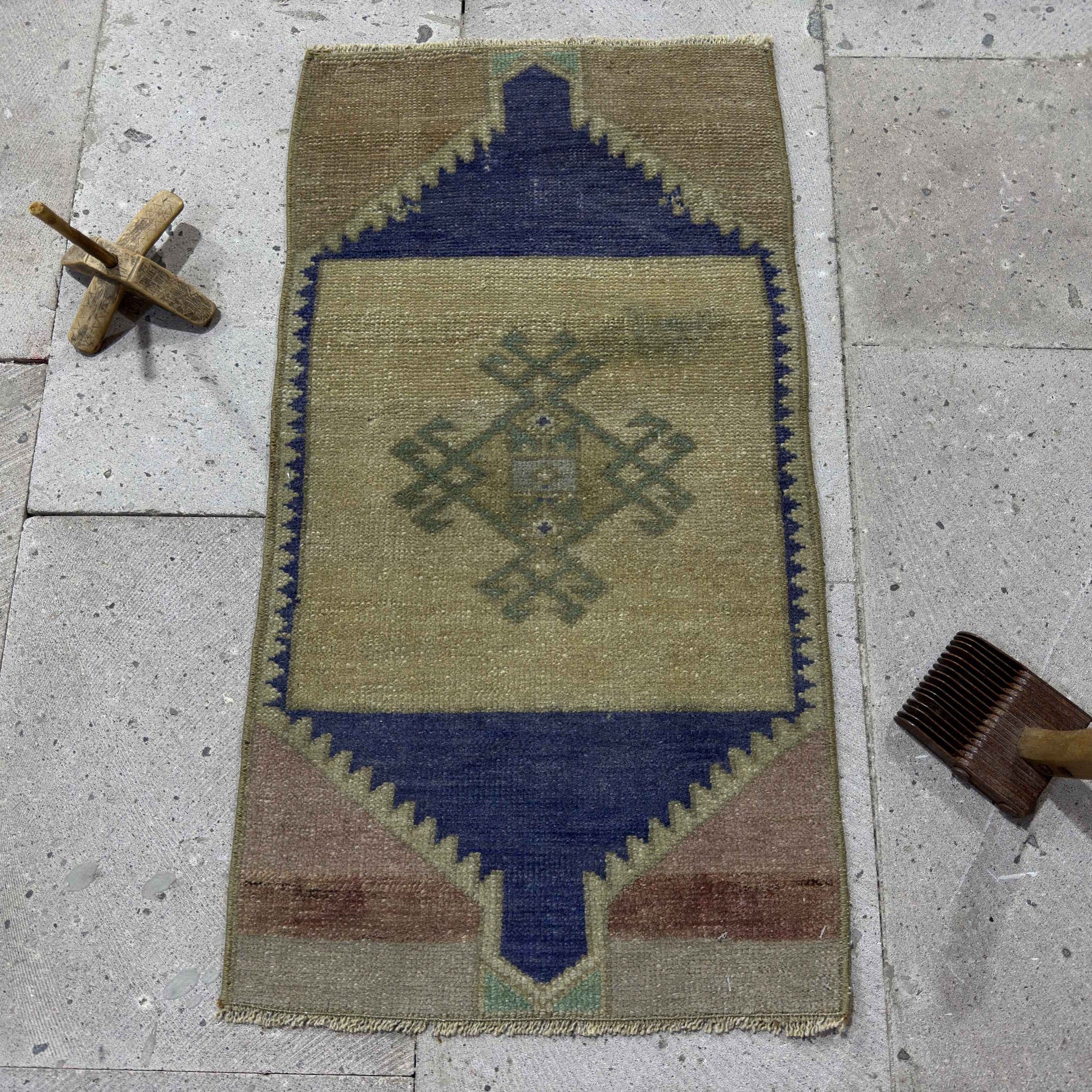 Blue 1' x 2' vintage Turkish small rug in wool and cotton, shown on the floor.