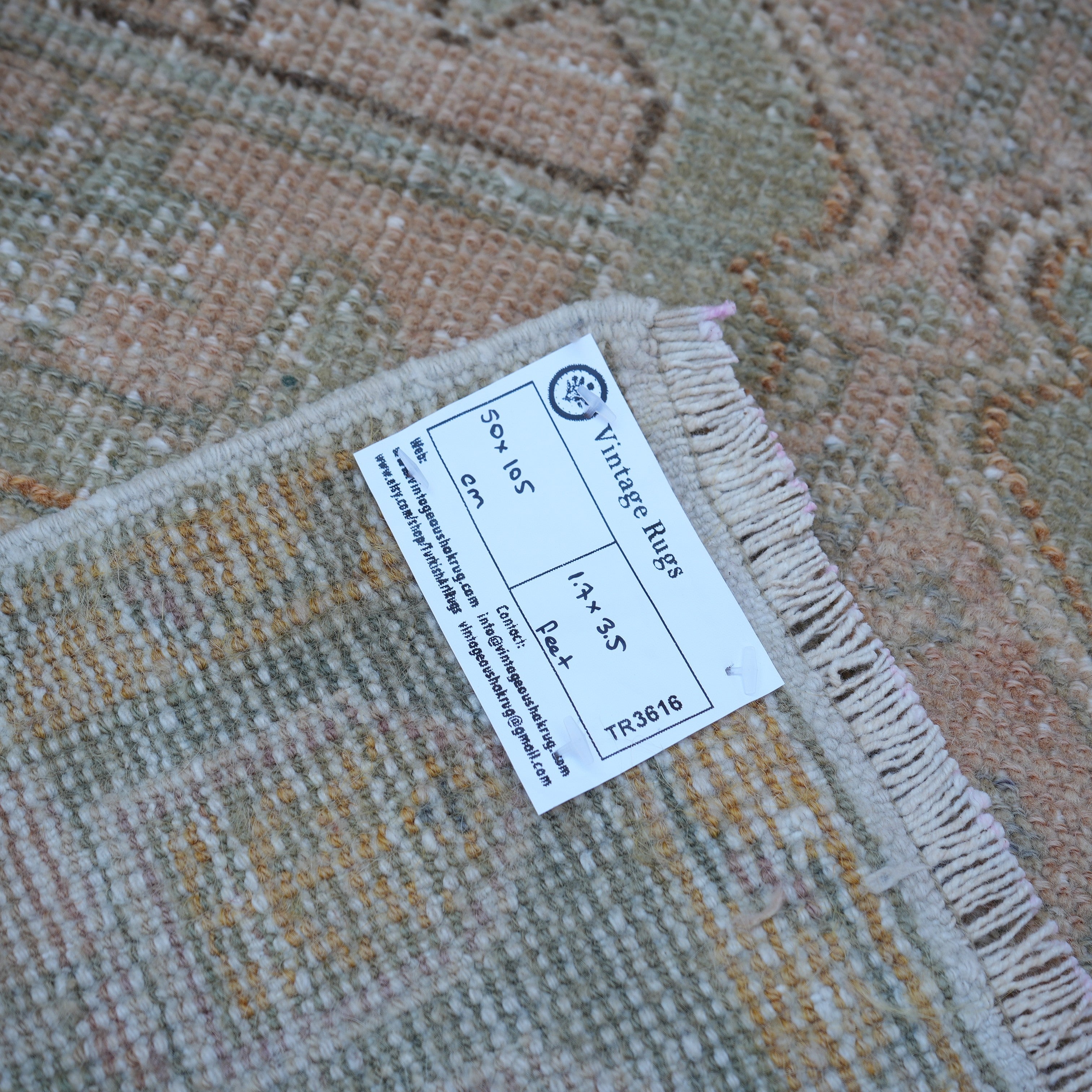 Pink 2' x 3' vintage Turkish small rug from the 1970s with neutral design.