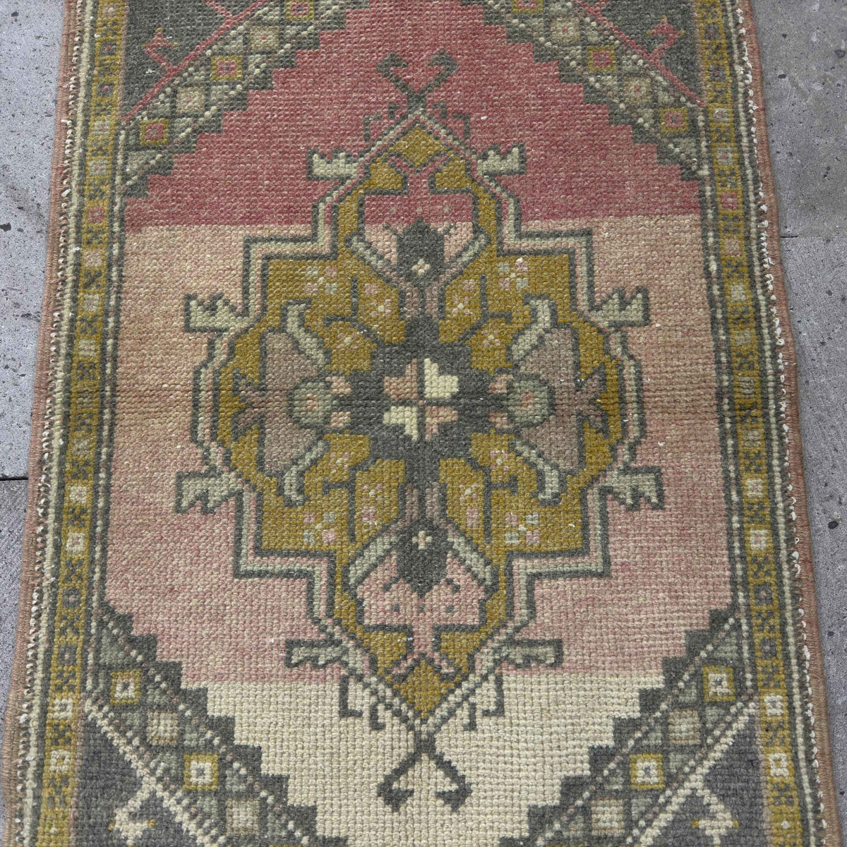 1970s pink vintage Turkish small rug with traditional design, hand-knotted weave and low pile.