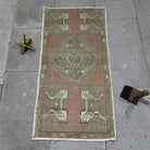 Red 2' x 3' vintage Turkish small rug in wool and cotton, shown on the floor.