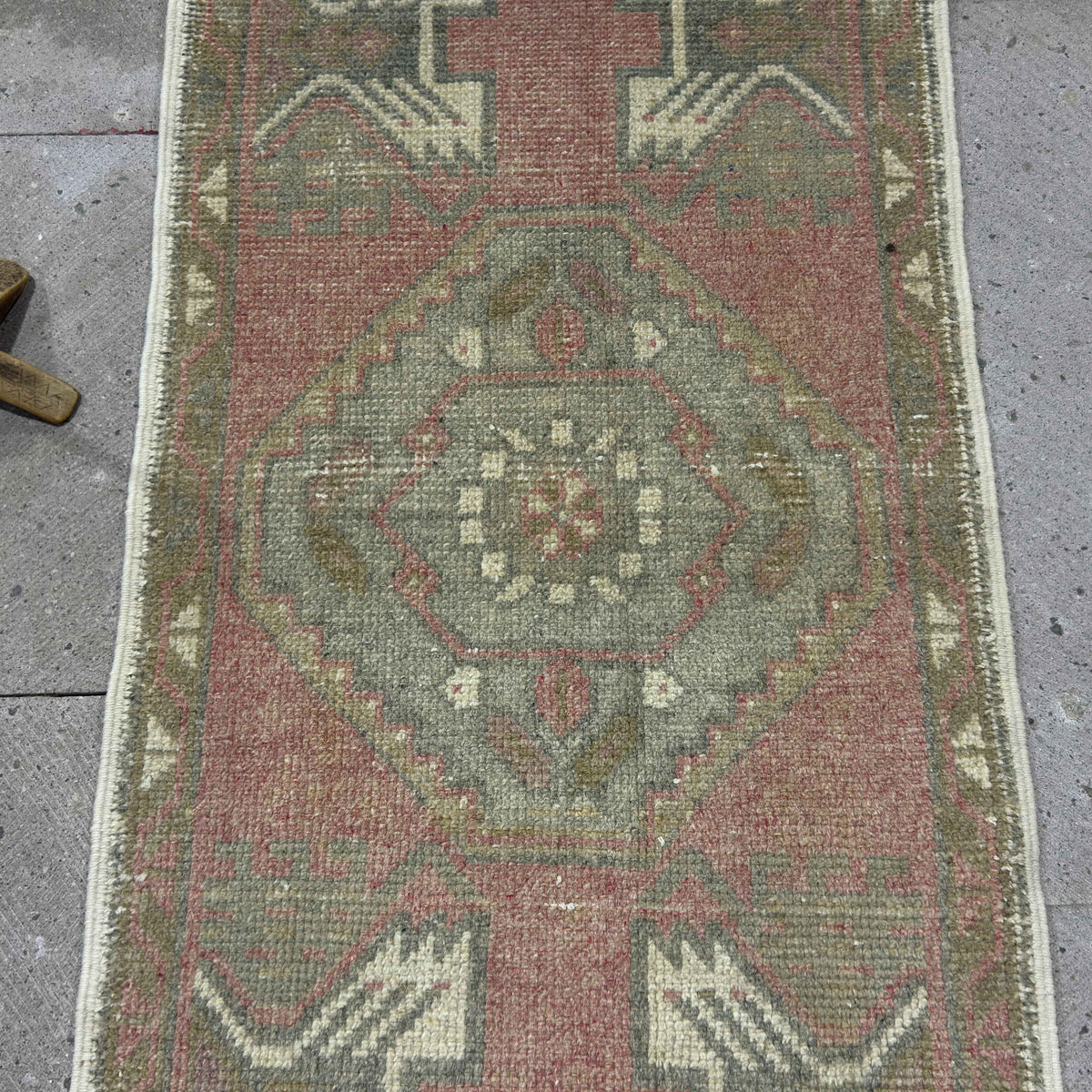 1970s red vintage Turkish small rug with traditional design, hand-knotted weave and low pile.
