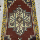 1970s red vintage Turkish small rug with traditional design, hand-knotted weave and low pile.