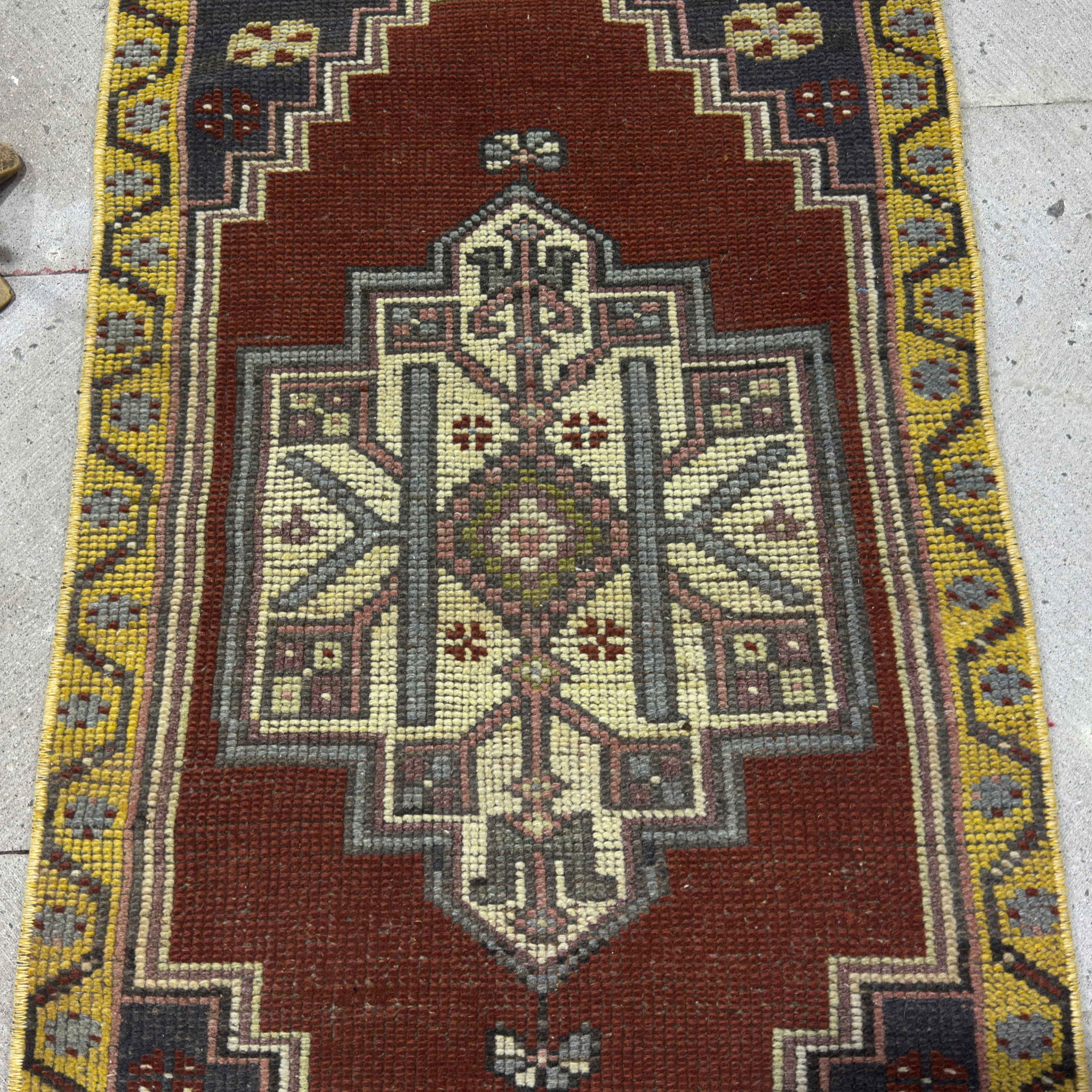 1970s red vintage Turkish small rug with traditional design, hand-knotted weave and low pile.