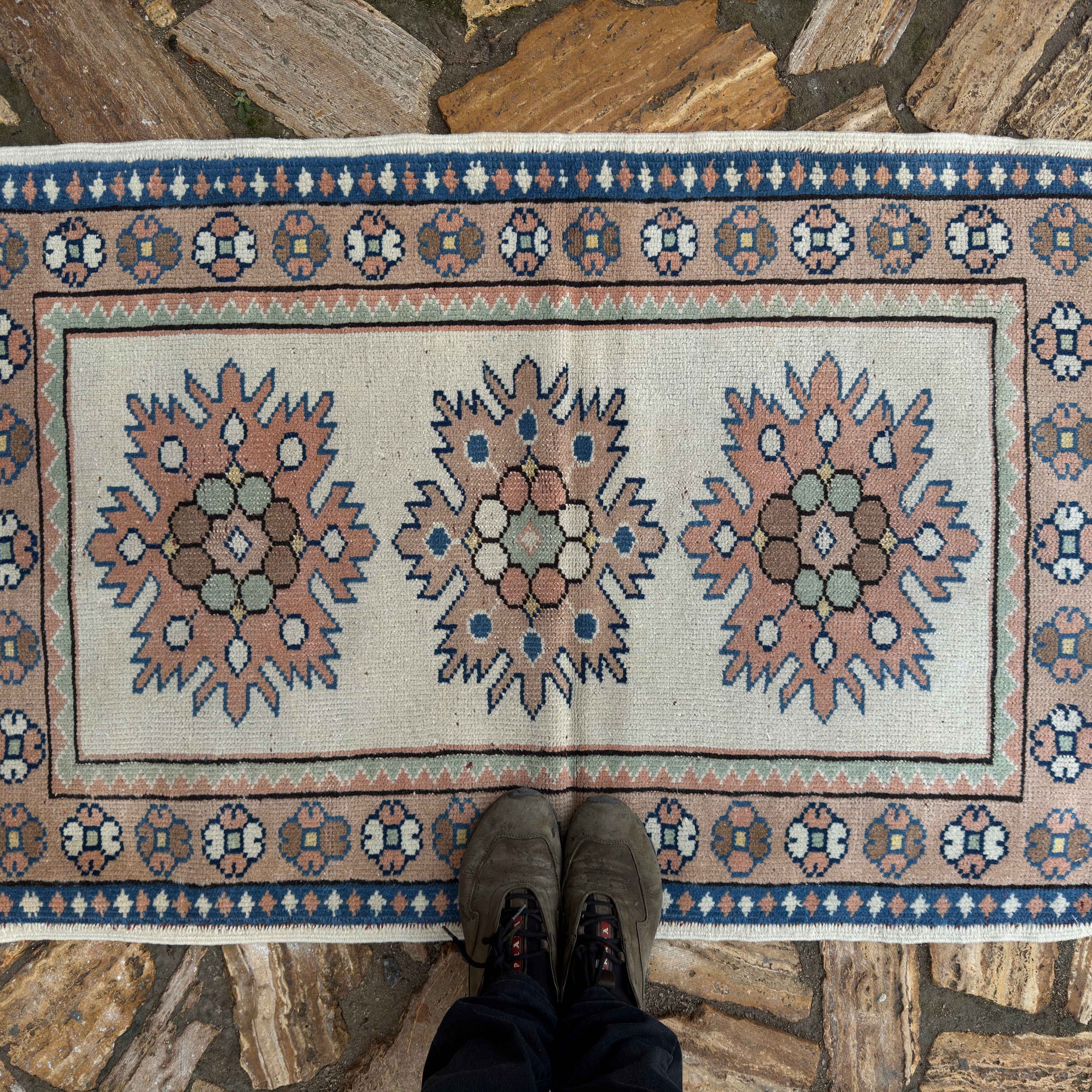 1970s beige vintage Turkish small rug with traditional design, hand-knotted weave and low pile.
