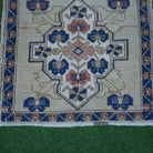 Close-up of the blue vintage Turkish square rug showing traditional details, hand-knotted weave, wool and cotton and low pile.