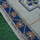 Blue 2' x 2' vintage Turkish square rug in wool and cotton, shown on the floor.